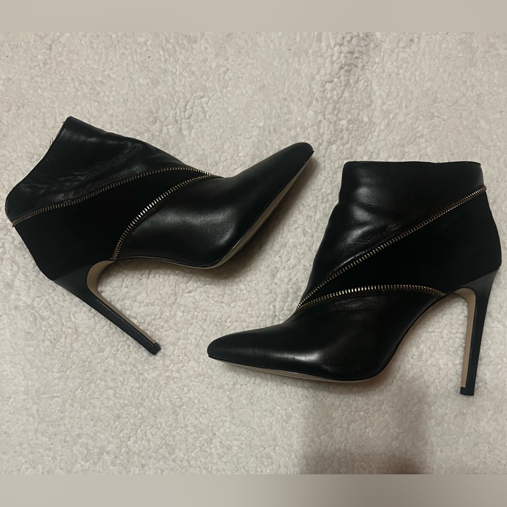 Black leather and suede booties with gold zipper detail, side zipper